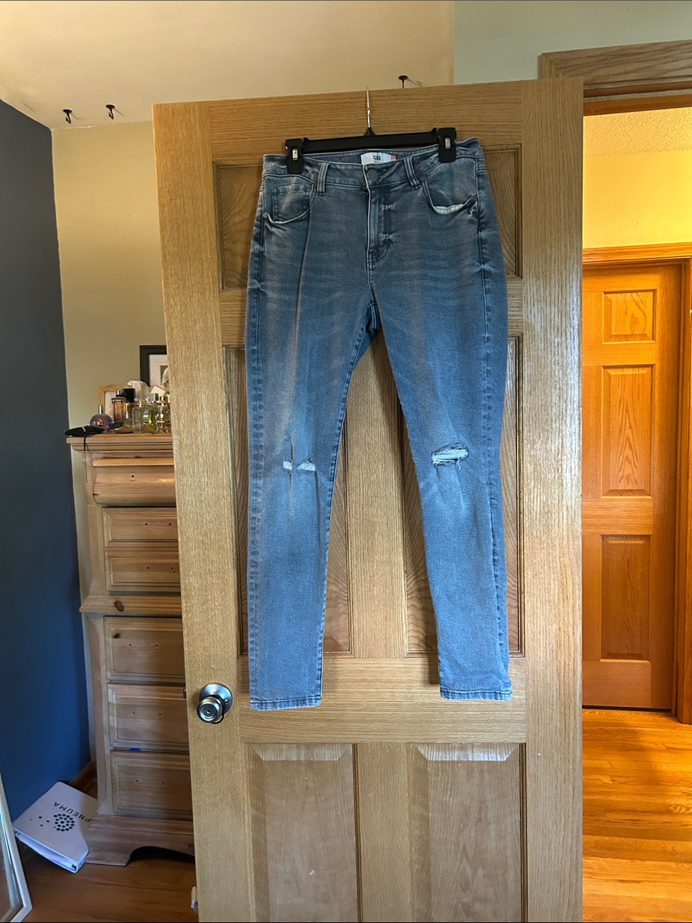 CAbi Women's Skinny Jeans - Faded Blue with Knee Distress